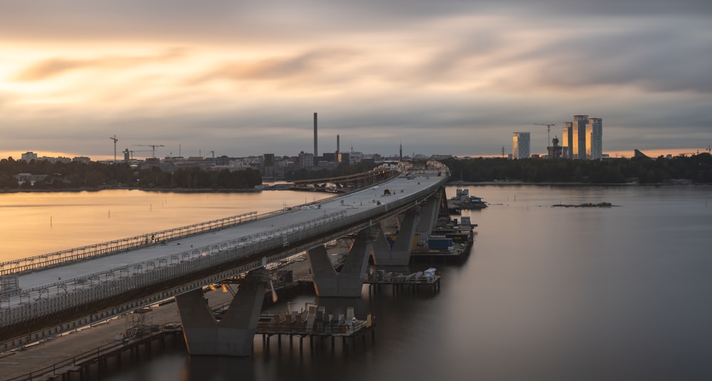 a bridge over a body of water with a city in the background