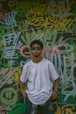 A stylish black and white 199 st. logo printed on a relaxed-fit t-shirt displayed against an urban graffiti wall.
