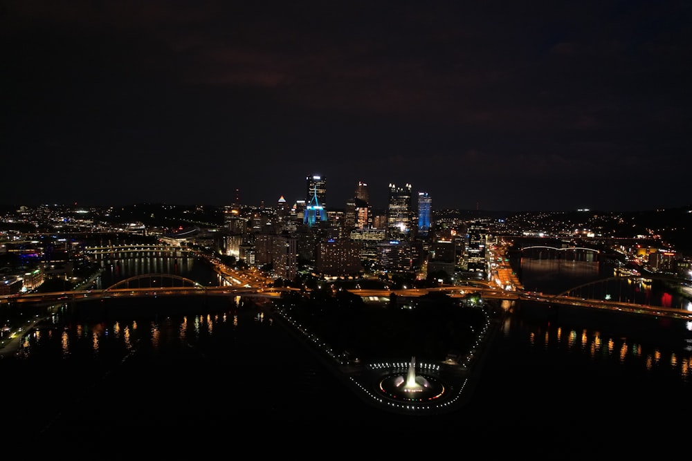 a view of a city at night from the top of a hill