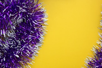 A vibrant display of Tinsel Stump Hawgs hanging against a grey background with yellow highlights.