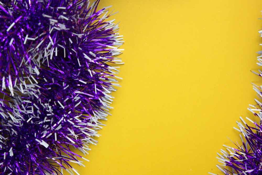 purple tinsel sprinkles on a yellow background
