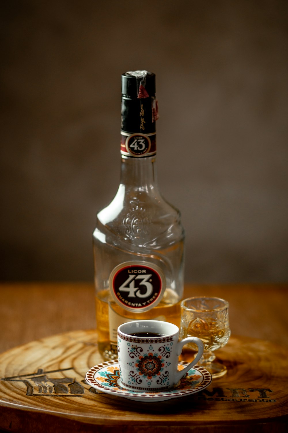 a bottle of alcohol sitting on top of a wooden table