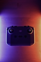 Drone operator controlling the drone with a remote in an olive and anthracite themed environment.