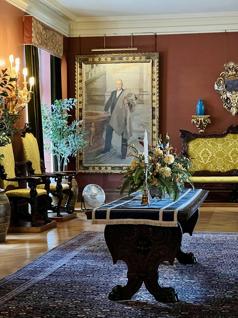 a living room filled with furniture and a painting on the wall