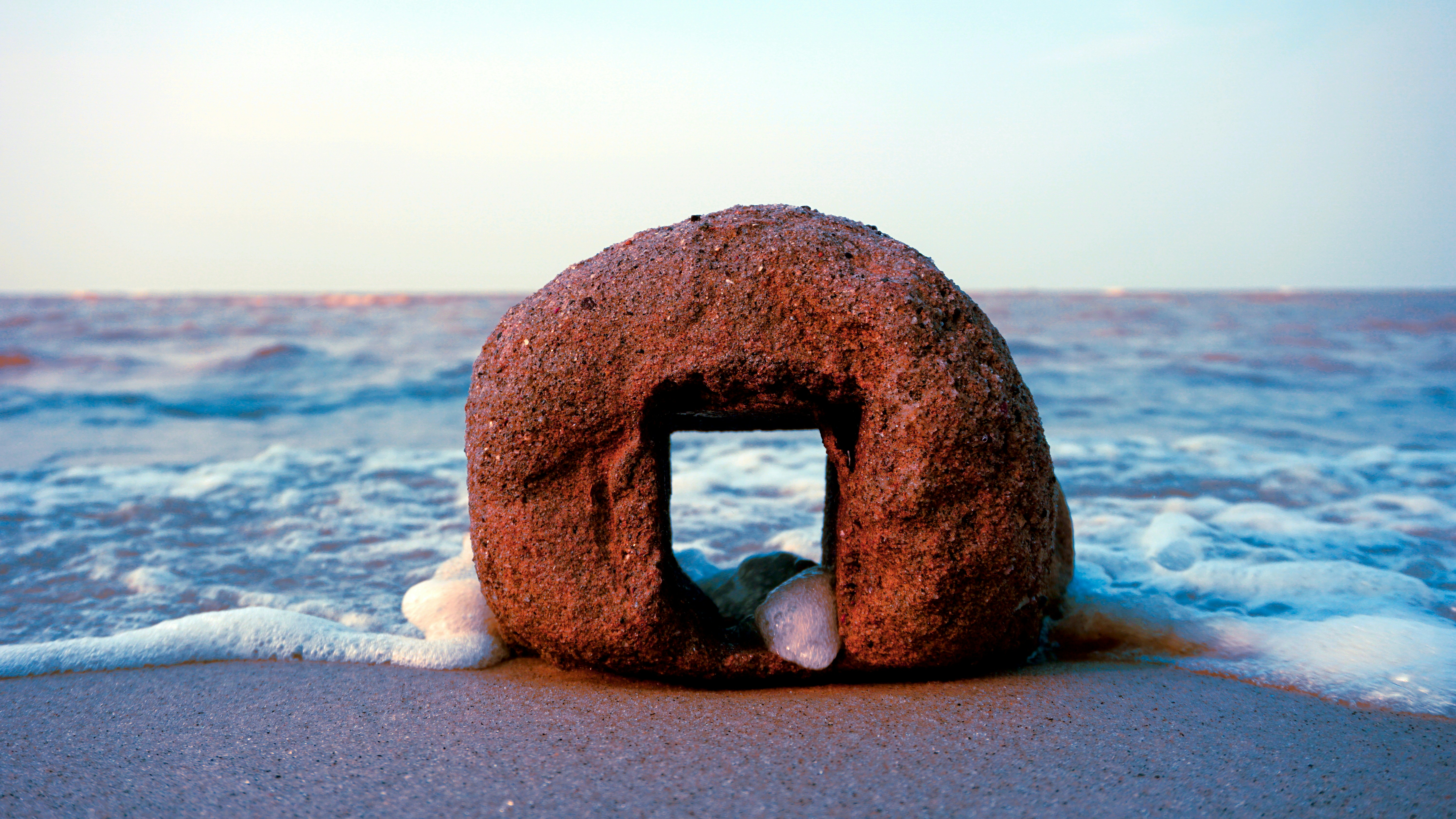 A large rock sitting on top of a sandy beach photo – Free Brown Image ...