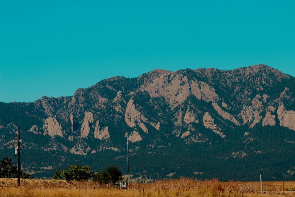 a mountain range with a telephone pole in the foreground