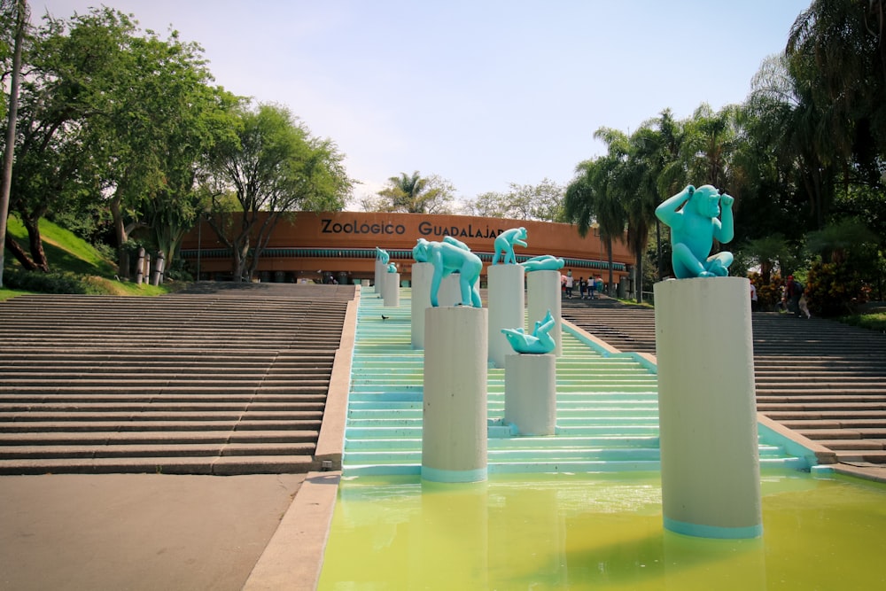 a group of blue elephants sitting on top of white pillars
