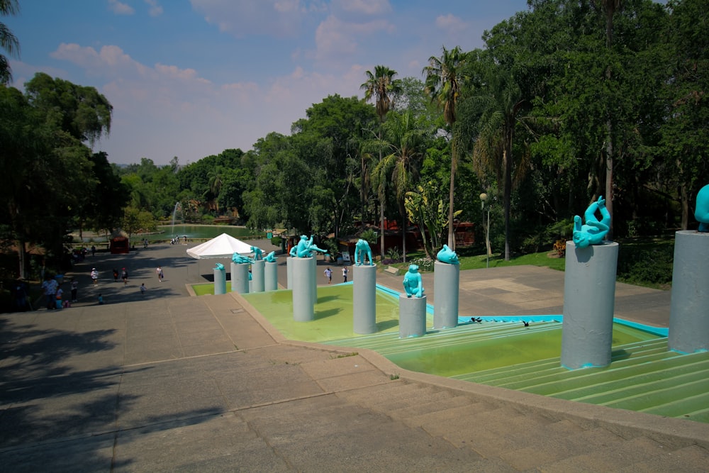 a group of blue sculptures sitting on top of a cement walkway