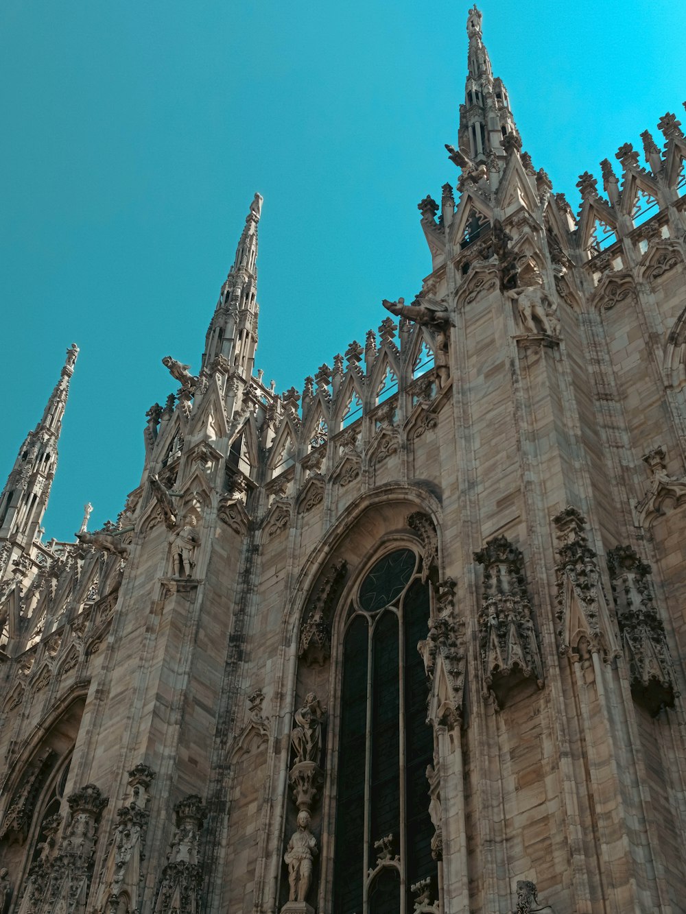 a very tall cathedral with statues on it's sides