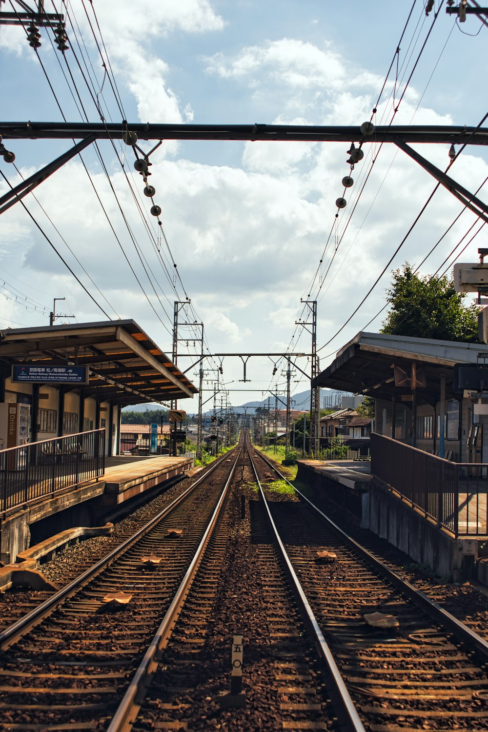 a train track with a train station in the background