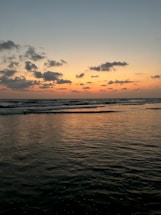 A serene ocean sunset with gentle waves, symbolizing peace and renewal.