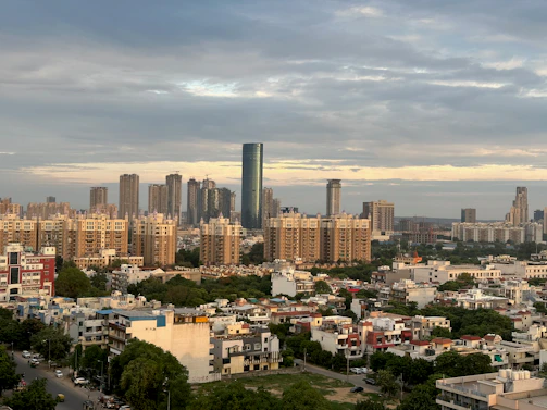 A panoramic shot of a Sai Skyline Infra residential complex bustling with happy residents enjoying modern amenities.