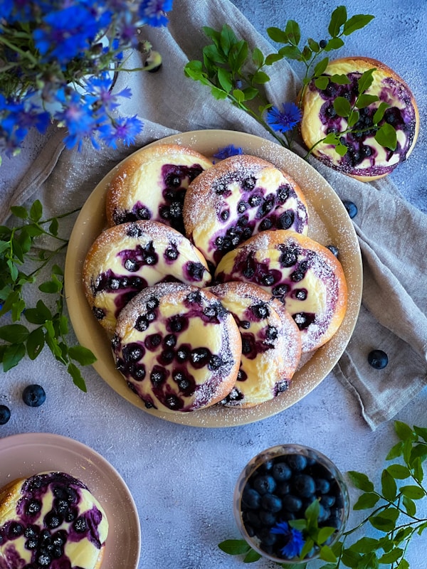 A plate of blueberry muffins on a table