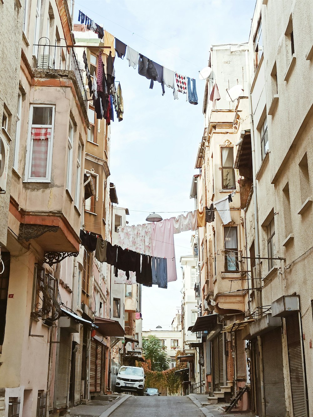 a car is parked on the street between two buildings