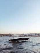 A sleek luxury yacht gliding through Miami’s turquoise waters under a clear blue sky.