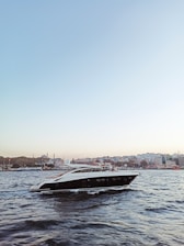 A sleek luxury yacht gliding through Miami’s turquoise waters under a clear blue sky.