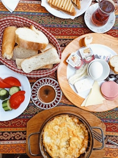 a table topped with plates of food and bread
