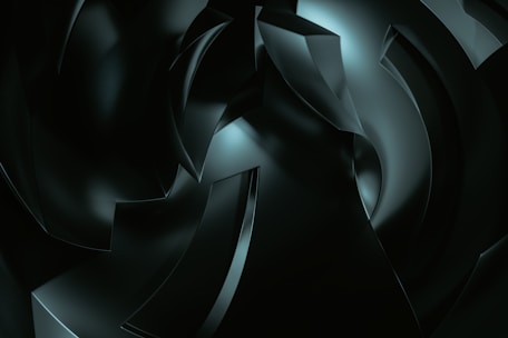 A digital artwork featuring abstract, curved shapes with a glossy finish, rendered in dark tones and illuminated by subtle highlights. The composition suggests depth and movement, with overlapping forms creating a sense of complexity.