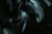 A digital artwork featuring abstract, curved shapes with a glossy finish, rendered in dark tones and illuminated by subtle highlights. The composition suggests depth and movement, with overlapping forms creating a sense of complexity.