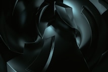 A digital artwork featuring abstract, curved shapes with a glossy finish, rendered in dark tones and illuminated by subtle highlights. The composition suggests depth and movement, with overlapping forms creating a sense of complexity.
