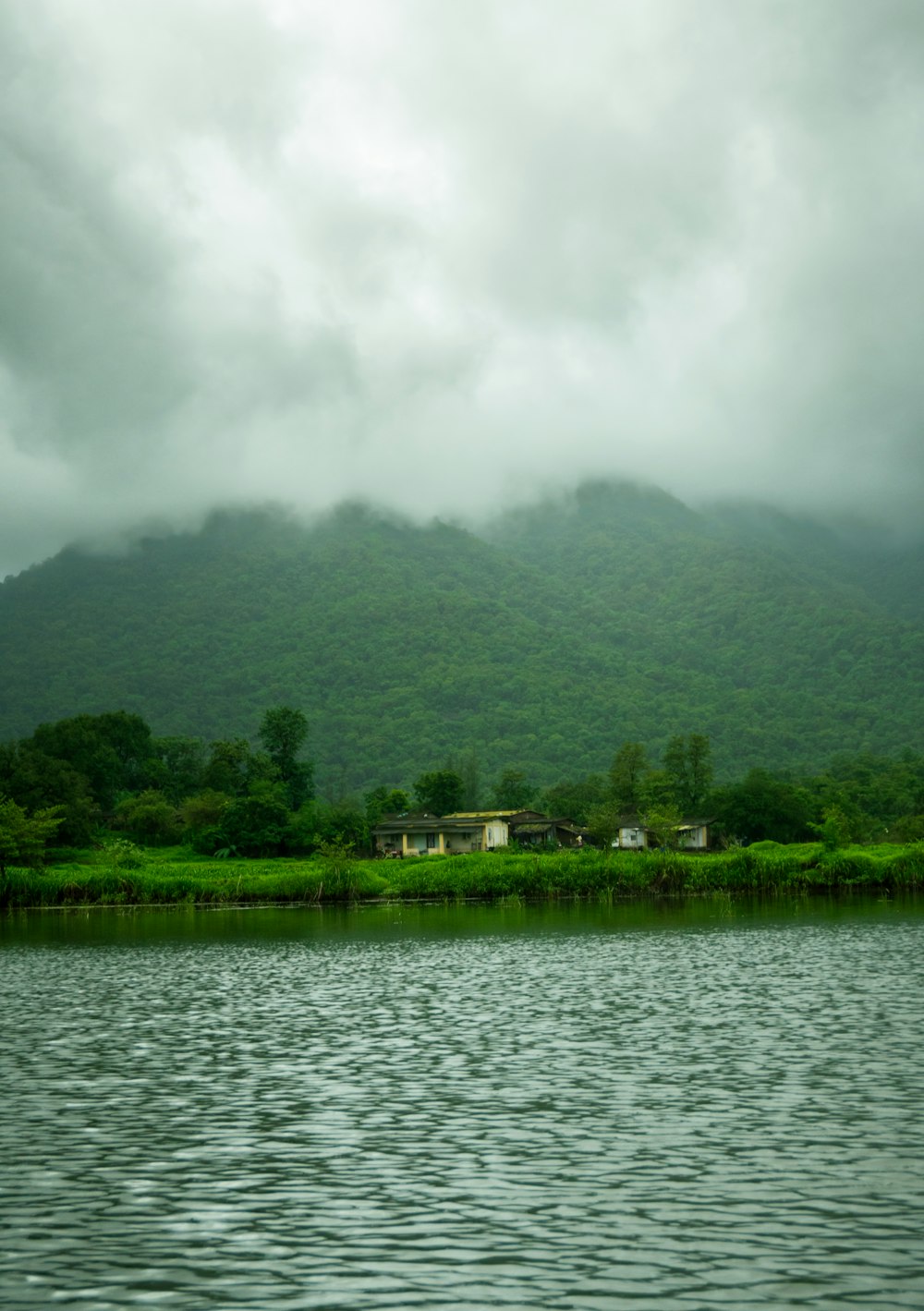 a body of water with a mountain in the background