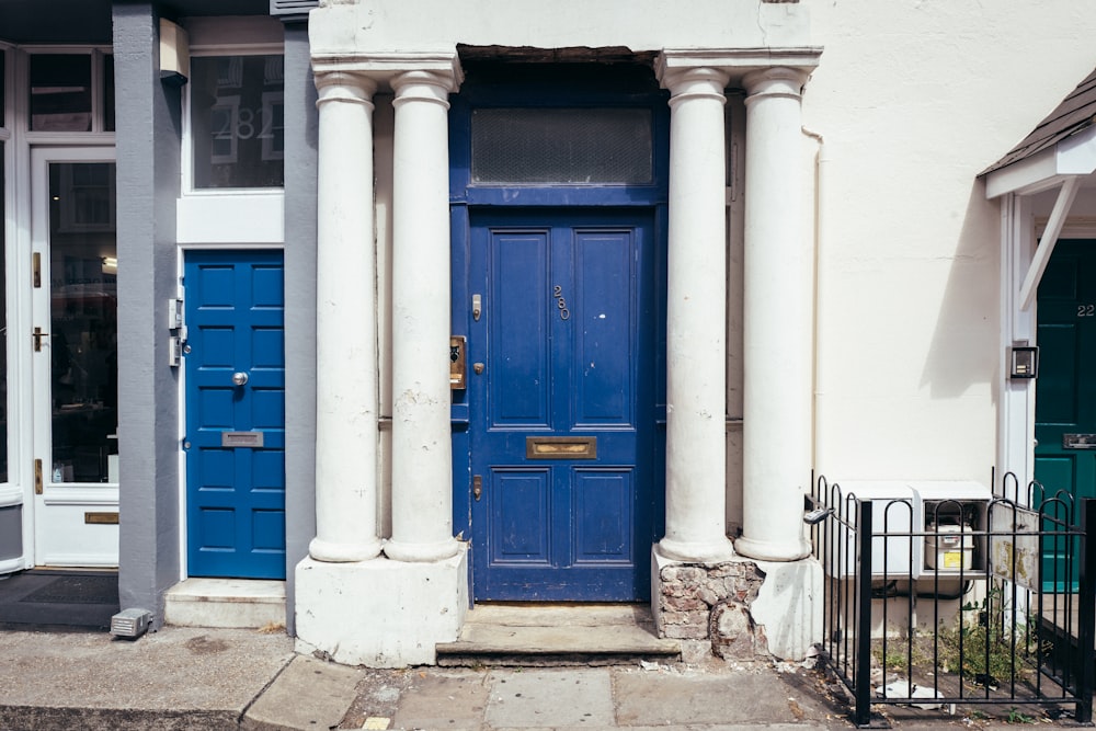 a blue door is in front of a white building