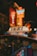 A taxi sign is prominently displayed, surrounded by a blur of colorful neon lights in the background, giving an urban nighttime vibe.