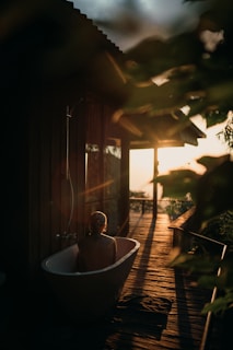 Warm outdoor hot water tub steaming gently at sunset in a rustic setting.