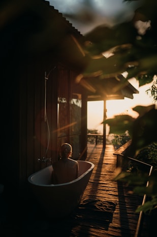 Warm outdoor hot water tub steaming gently at sunset in a rustic setting.