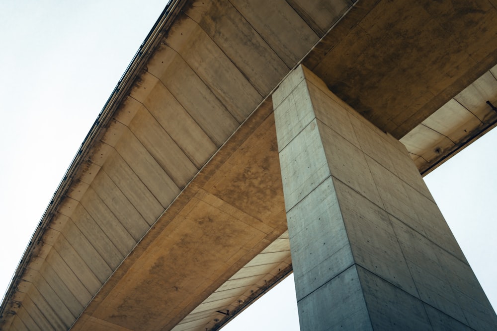 the underside of a bridge with a sky in the background