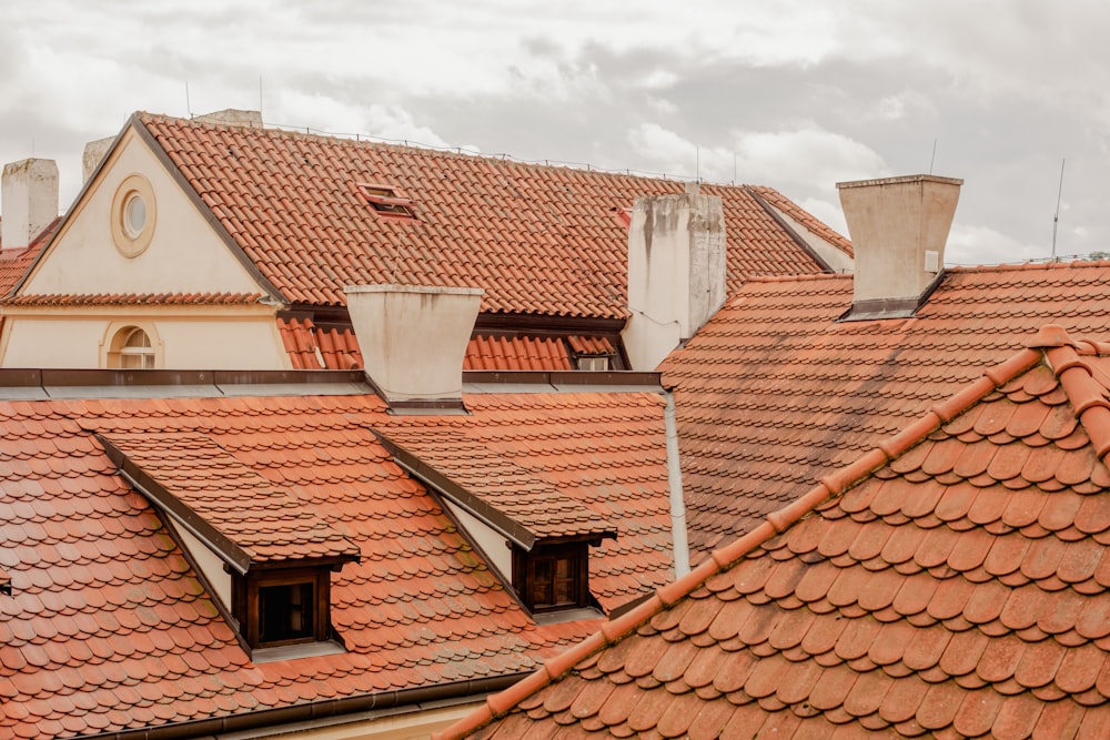 a row of rooftops with red tiled roofs