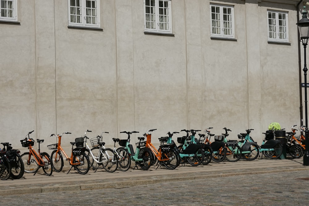 a row of bicycles parked next to a building