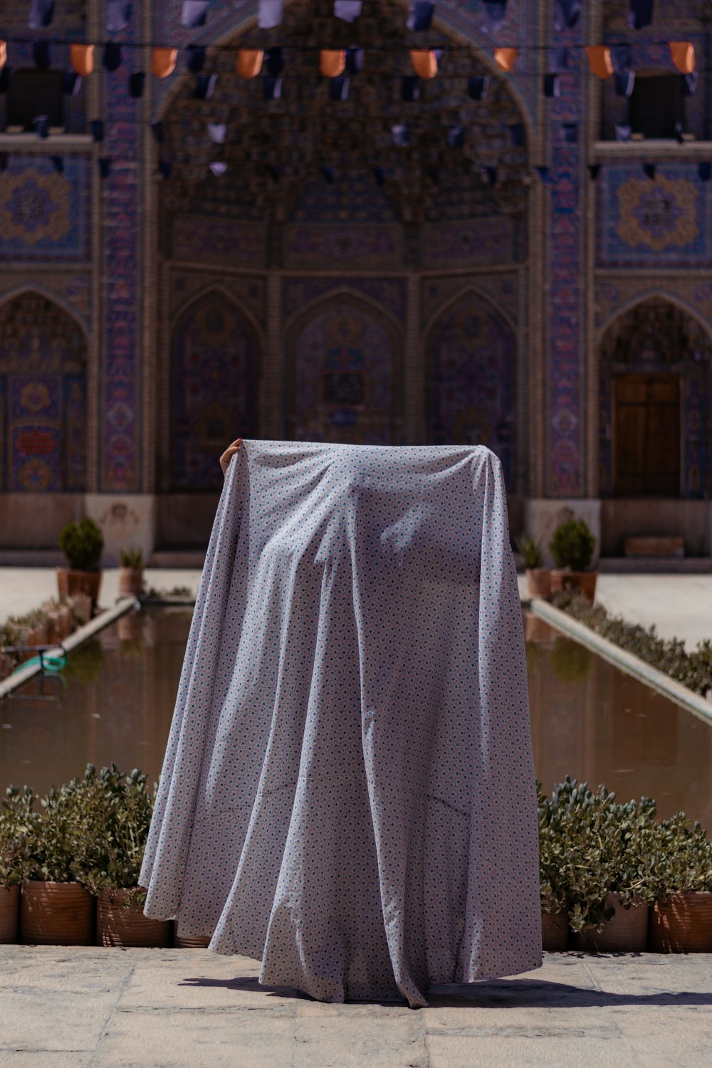 a table covered with a white cloth in front of a building