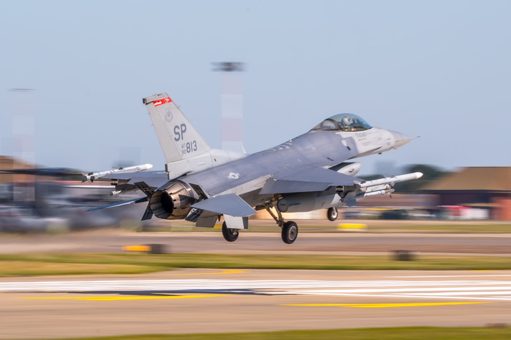 a fighter jet taking off from an airport runway