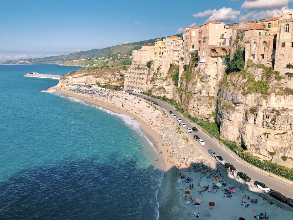 an aerial view of a beach with a cliff in the background