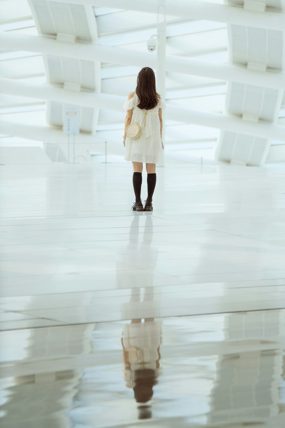 a woman in a white dress and black boots