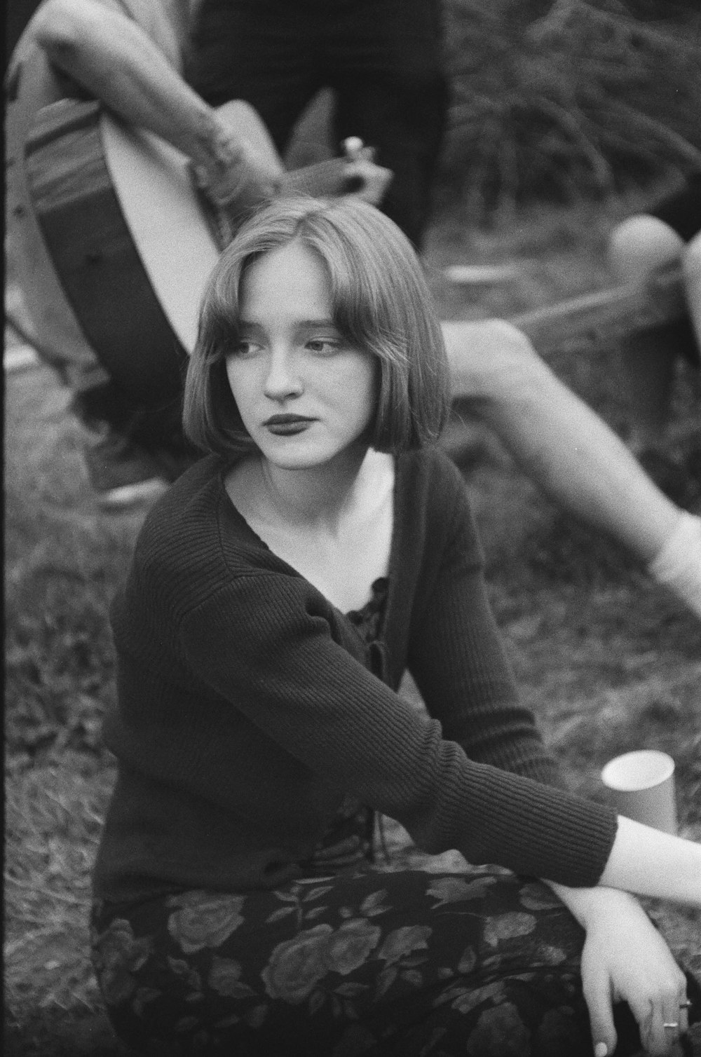 a black and white photo of a woman with a guitar