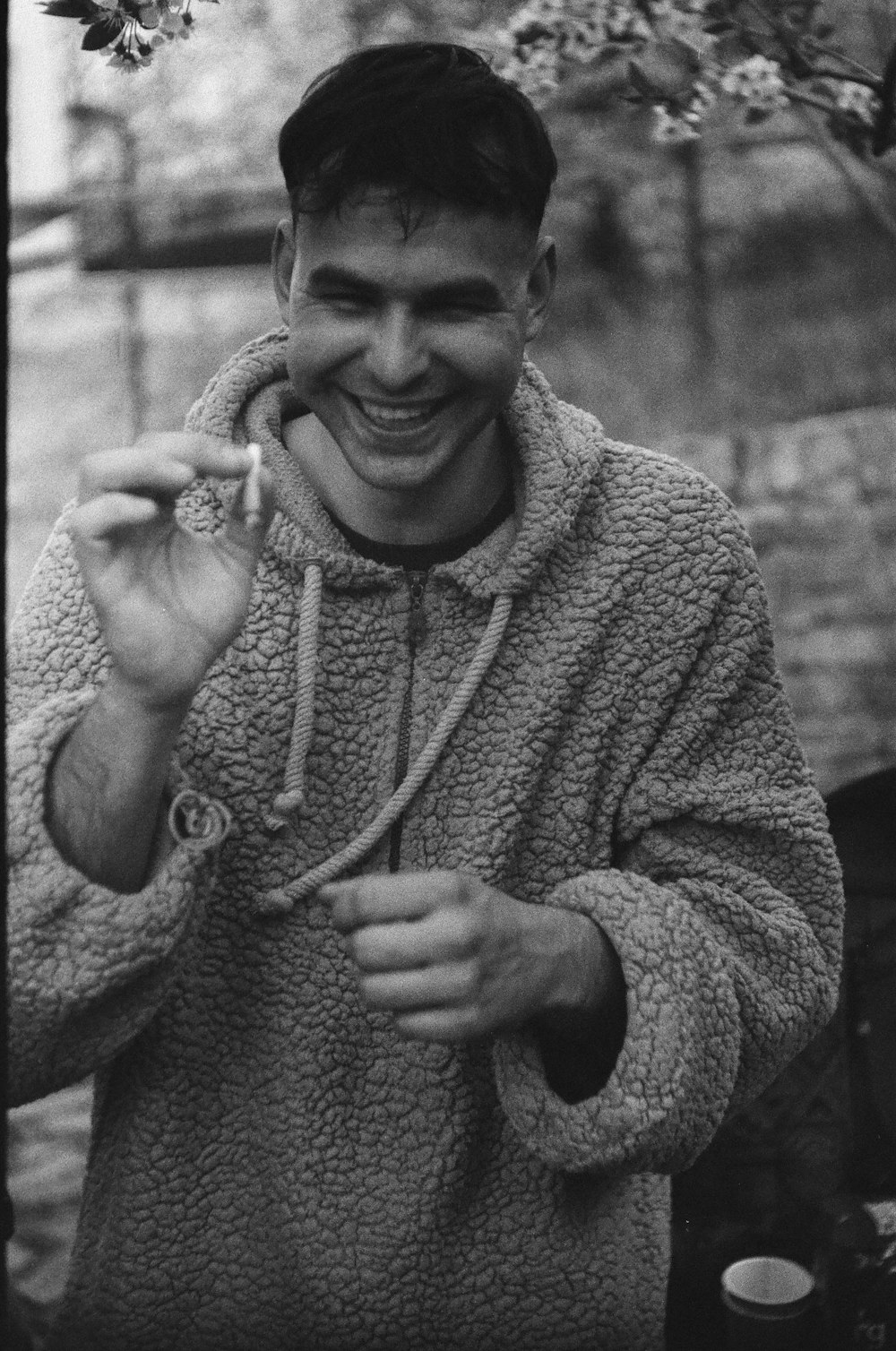 a black and white photo of a man laughing