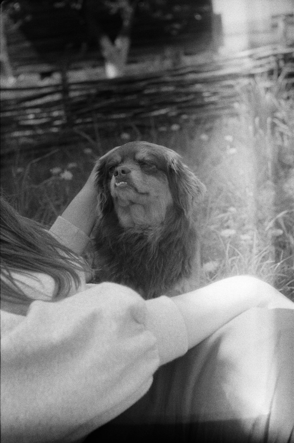 a black and white photo of a woman and a dog