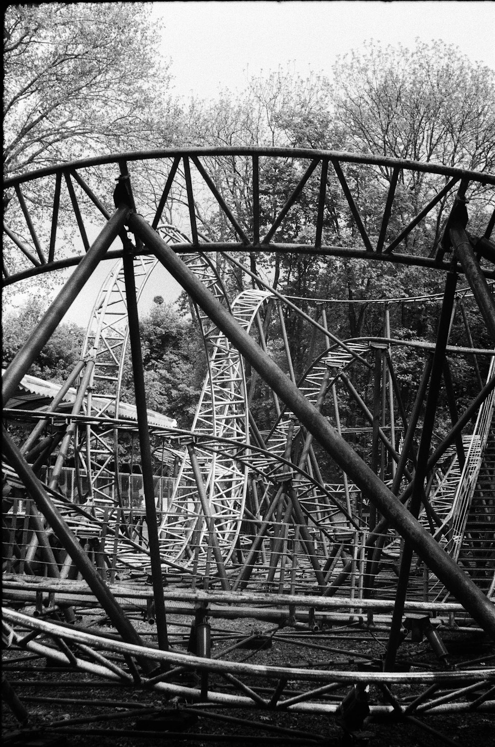 a black and white photo of a roller coaster