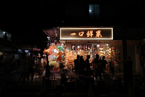 Colorful lanterns illuminating the night market streets of Shanghai.