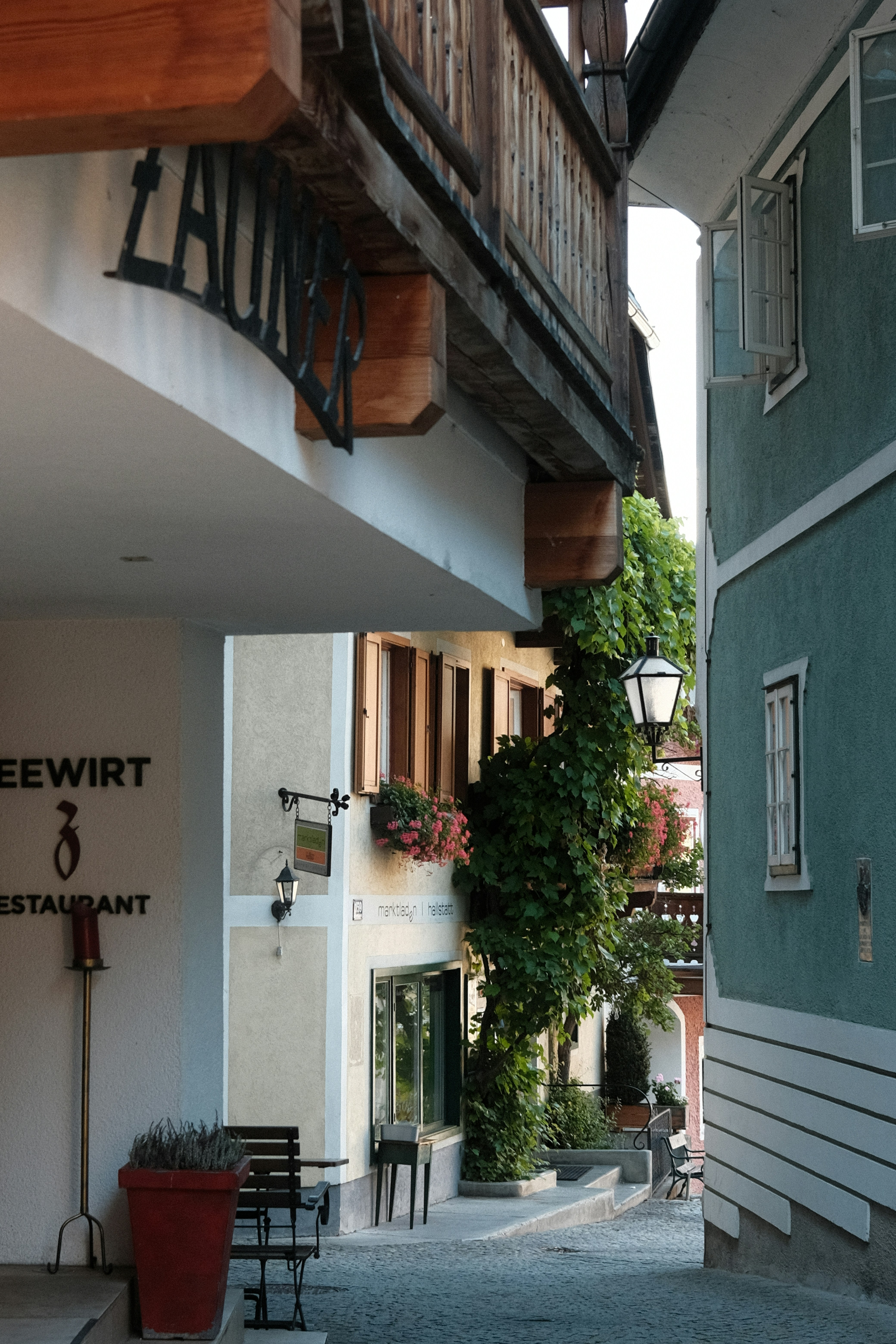 a building with a balcony and a sign on the side of it