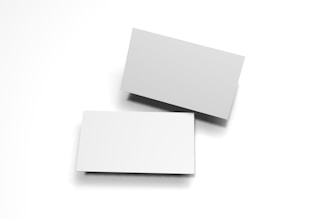 Two blank white business cards are placed against a white background. One card is slightly elevated and casts a shadow, creating a simple, minimalist composition.