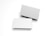 Two blank white business cards are placed against a white background. One card is slightly elevated and casts a shadow, creating a simple, minimalist composition.