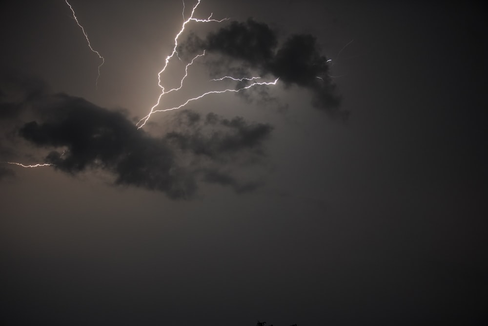 a large cloud with a lightning bolt in the sky