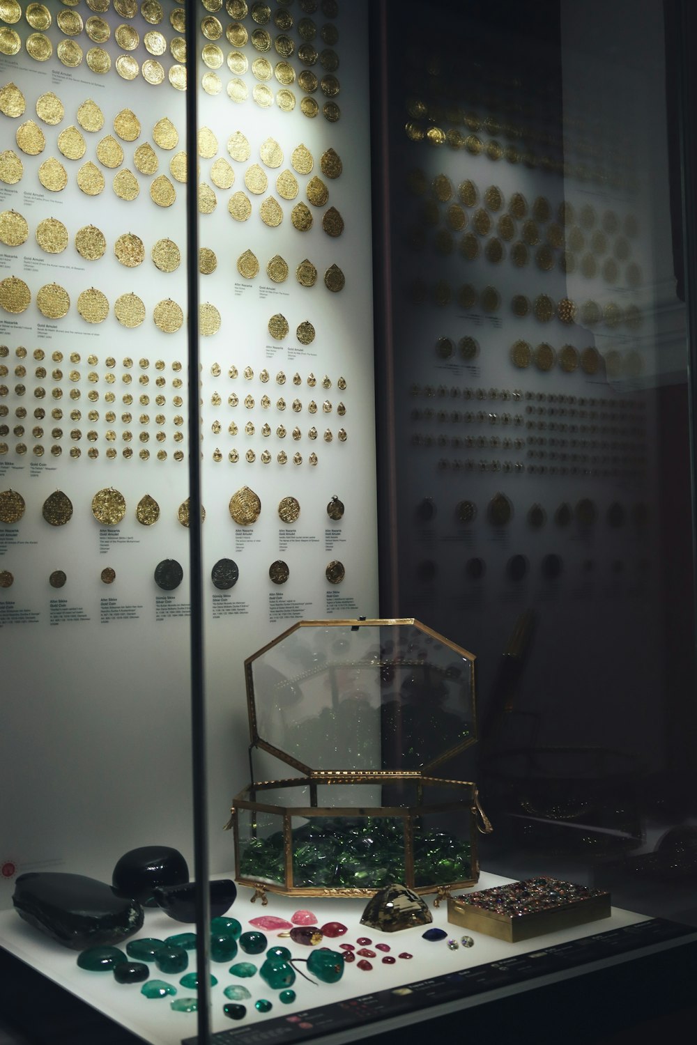 a display case with a variety of gold coins