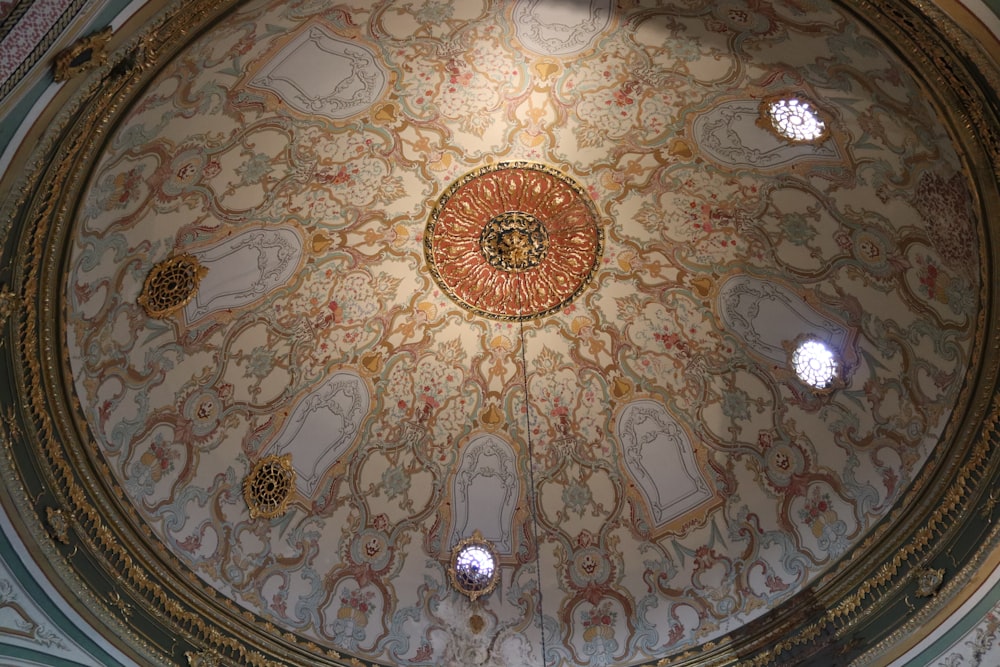 the ceiling of a building with a circular design on it