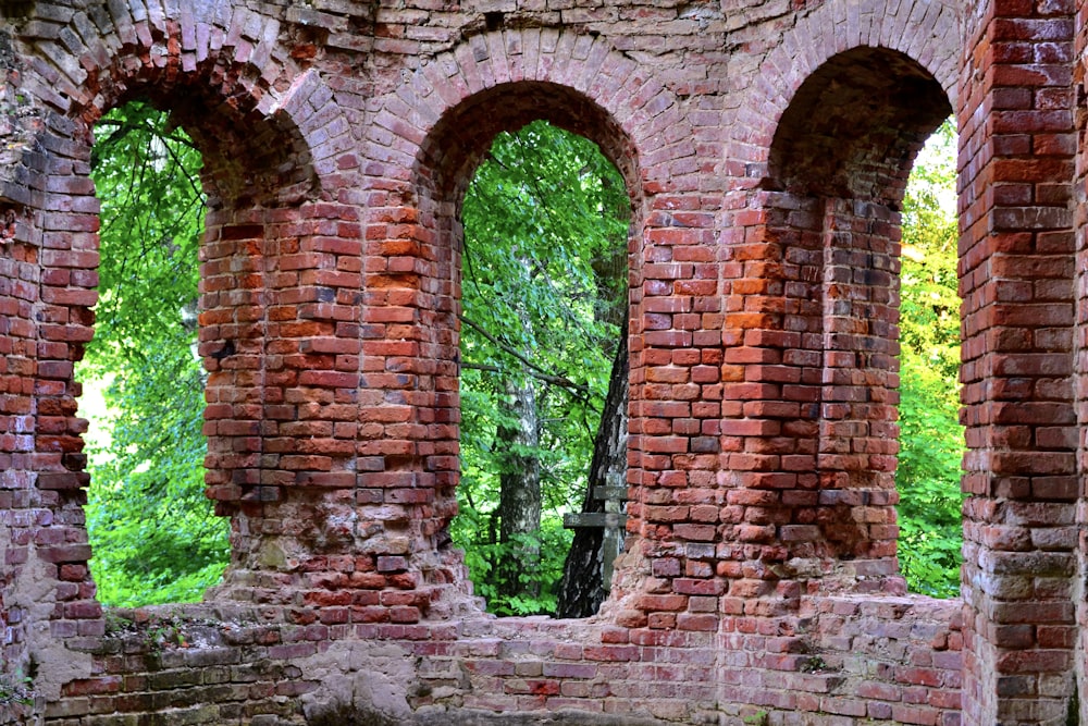 an old brick building with four arched windows