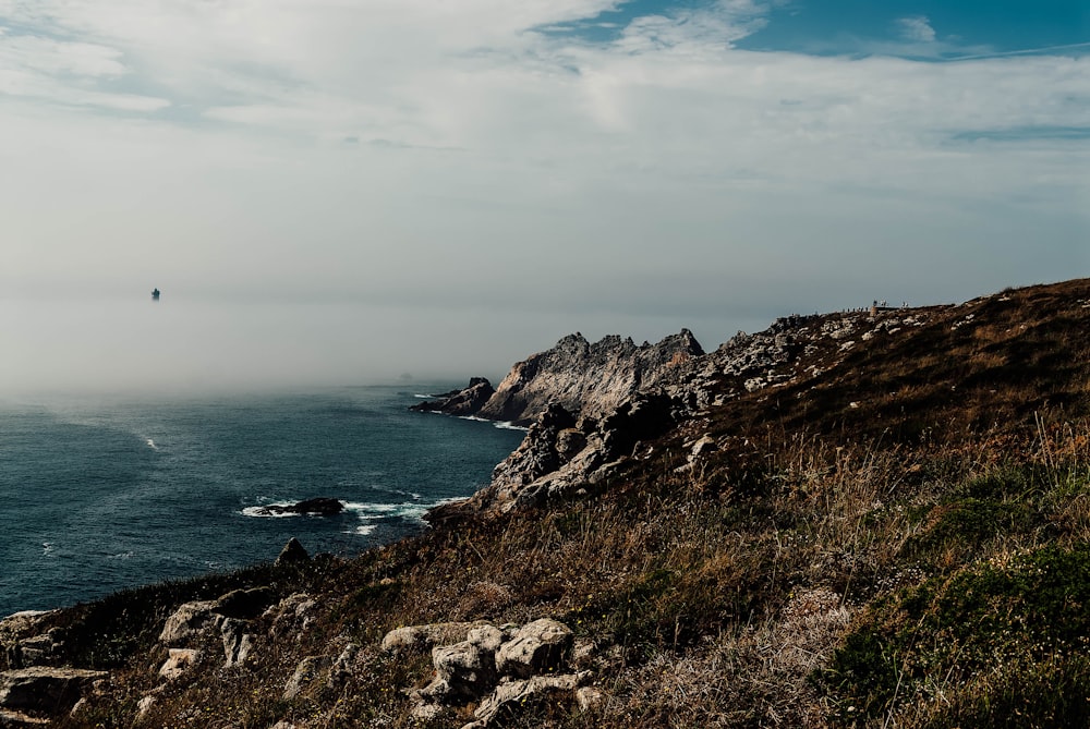 a view of the ocean from a rocky cliff