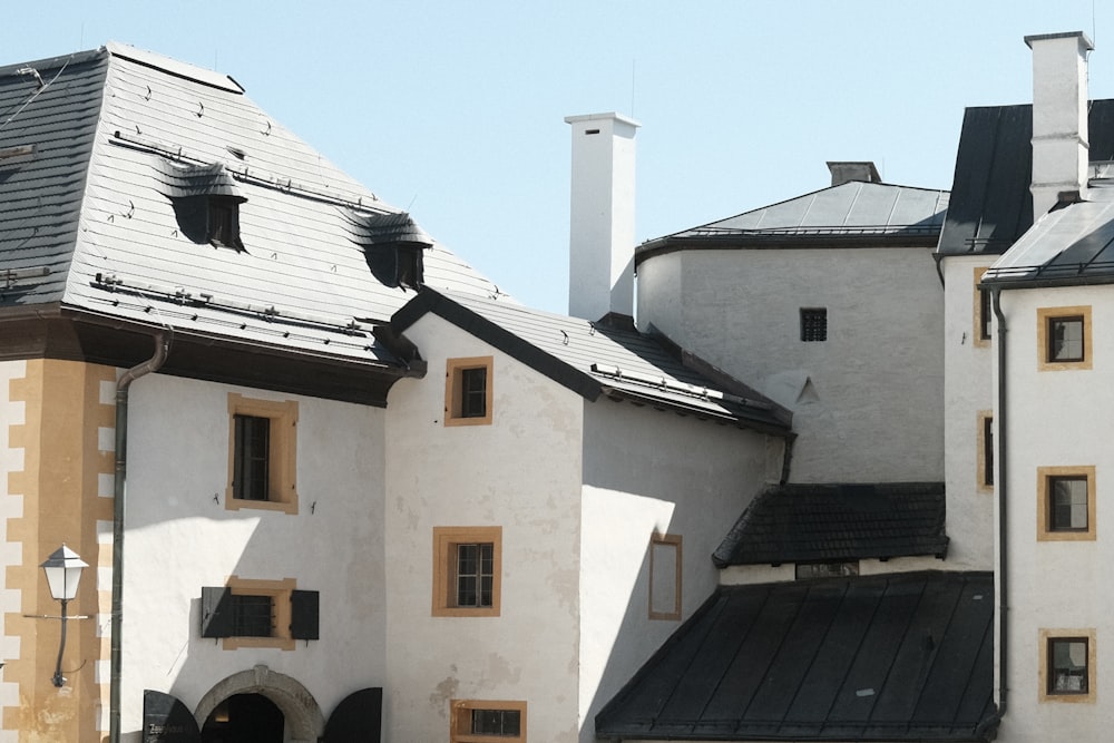 a large white building with a black roof